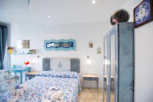 a small bedroom with a bed and a table at Versomare in Polignano a Mare