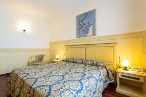 Letto o letti in una camera di Albergo Il Cacciatore