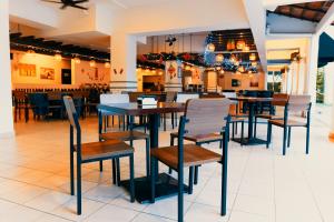 a dining room with tables and chairs in a restaurant at Tiara Desaru Resort in Desaru