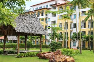 a building in front of a park with a building at Tiara Desaru Resort in Desaru