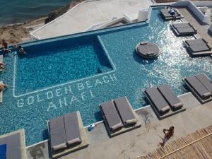 an overhead view of a swimming pool with chaise lounge chairs at Golden Beach Resort Anafi in Anafi