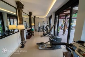 a fitness room with treadmills and a gym at Villa Klang Wiang in Chiang Mai