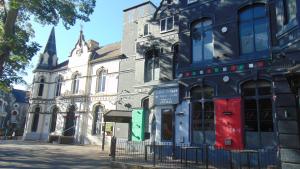 a building on a city street with a church at The Dorchester Serviced Apartments in Hull