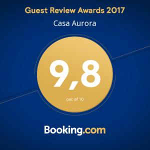 een gele cirkel met de woorden Quest Review Awards erop bij Casa Aurora in Sedrun