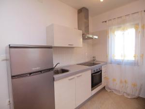 a kitchen with a refrigerator and a sink at Apartment Jasminka-1 by Interhome in Drage