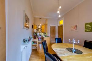 cocina y comedor con mesa y sillas en ALTIDO Modern 3 bed flat, closeby the Meadows & Old Town en Edimburgo