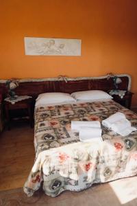 a bed with a blanket and pillows on top of it at Red Fenice in San Donà di Piave