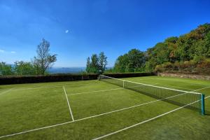 a tennis court with two tennis courts at Gellino by PosarelliVillas in Misciano