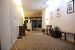 a room with a hallway with a table and chairs at Hotel Gaon J Stay in Seogwipo