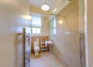 a bathroom with a toilet and a sink at ALTIDO Modern 3 bed flat, closeby the Meadows & Old Town in Edinburgh
