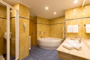 y baño con bañera, lavamanos y ducha. en Hotel Santamaria, en Tudela