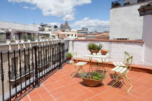 a patio with a table and chairs on a balcony at Apartamentos Mayor Centro in Madrid
