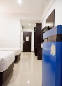 Postel nebo postele na pokoji v ubytování Izen Budget Hotel & Residence