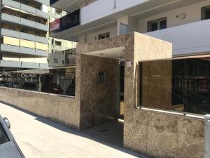 a building with a stone wall in front of a building at Bari Lory’s Home in Bari