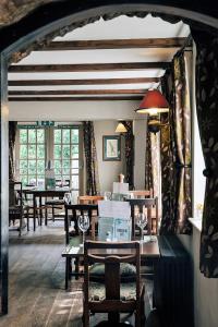 a dining room with tables and chairs and windows at Rose And Crown in Porthcawl
