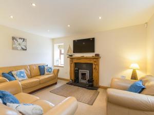 a living room with two couches and a fireplace at Portknockie 17 Harbour Place Overlooking Harbour in Portknockie