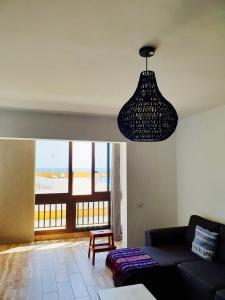 a living room with a couch and a pendant light at Beach Apartment Poris in Poris de Abona