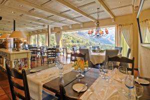 a dining room with tables and chairs and a large window at Ristorante della Stazione da YanElo in Intragna