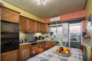 - une cuisine avec une table et un bol de fruits dans l'établissement 165 sm Penthouse Maisonette Apartment, à Athènes
