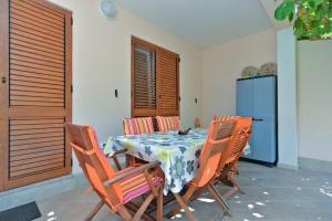 a dining room with a table and four chairs at Apartment Snjezana 1064 in Rovinj