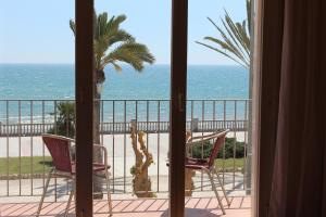 a room with a view of the ocean from a balcony at La Santa María in Sitges