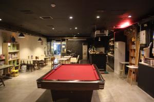 a pool table in the middle of a room at Hotel Gaon J Stay in Seogwipo