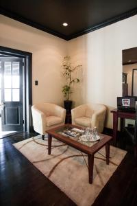 a living room with two chairs and a coffee table at Firlane House in Bredasdorp