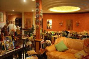 a living room with a couch in a room with tables at Tilly's B&B and apartment house in Le Hohwald