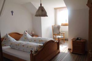 a bedroom with a bed with a cross on it at Appartementhaus "Haflinger Hof" in Bad Füssing