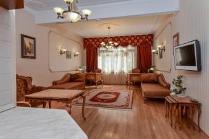 a living room filled with furniture and a tv at Aristocratic Sofia Studio Apartment Next to Cathedral in Sofia