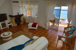 a living room with a couch and a table and a television at Casa Miramar in Gran Tarajal