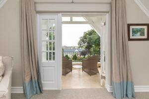 a living room with a door leading to a patio at Oxford Healthcare Retreat in Johannesburg