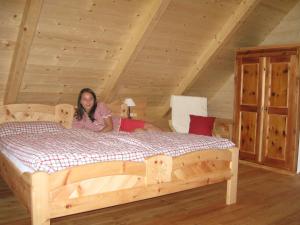 a woman laying on a bed in a attic at Pichelhütte in Murau