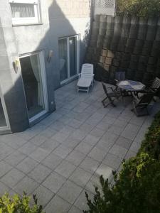 a patio with a table and chairs and a table and chairs at Moderne Wohnung in Elz in Elz