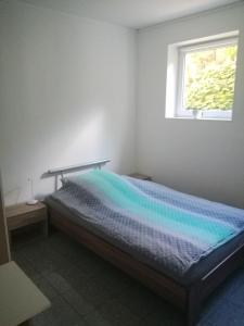 a bedroom with a bed with a rainbow colored blanket at Moderne Wohnung in Elz in Elz