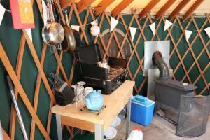 a room with a kitchen with a stove and a stove at Yurtcamp Devon in Newton Abbot