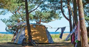 a tent with a bike parked in front of it at Dueodde Strand Camping in Dueodde