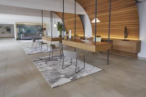 a lobby with tables and chairs in a building at Bordoy Alcudia Port Suites in Port d'Alcudia