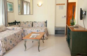 a living room with a couch and a table at Apartamentos Carabela II in Paguera