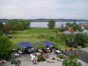 an aerial view of a park with tables and umbrellas at Insel-Hof Reichenau Hotel-garni in Reichenau