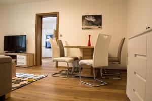a dining room with a table and chairs at Apartmány Karina in Janske Lazne