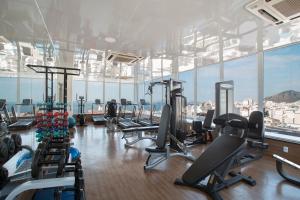 a gym with a bunch of treadmills and machines at Residencial Budget in Rio de Janeiro