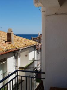 a view from a balcony of two white buildings at Marquina in Cadaqués +3 photos
