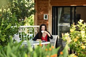 a woman sitting at a table with a cup of coffee at S3 Seahorse Beach Club in Oludeniz