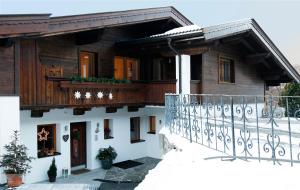 a house with a balcony and a fence at Haus Schmetterling in Alpbach