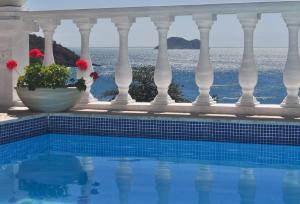 a swimming pool with a view of the ocean at Casagrande Hotel Boutique in Búzios