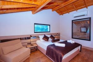 a bedroom with a bed and a couch at S3 Seahorse Beach Club in Oludeniz
