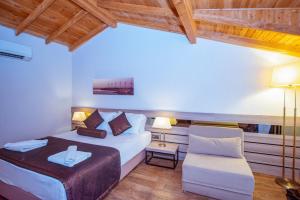 a hotel room with a bed and a chair at S3 Seahorse Beach Club in Oludeniz