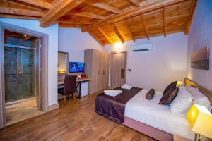 a bedroom with a bed and a desk in a room at S3 Seahorse Beach Club in Oludeniz