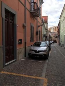 a car parked on the side of a street at B&B Juighissa Leonora in Oristano